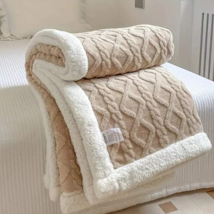 Sherpa verzwaringsdeken op een bed
