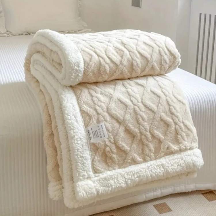 Sherpa verzwaringsdeken op een bed