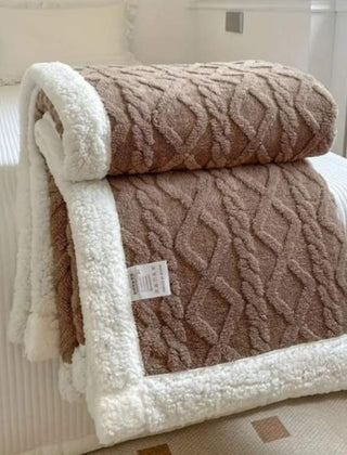 Sherpa verzwaringsdeken op een bed