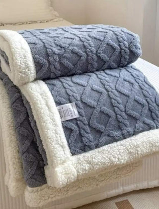 Sherpa verzwaringsdeken op een bed