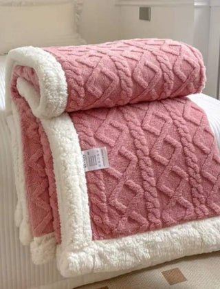 Sherpa verzwaringsdeken op een bed