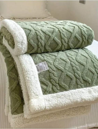 Sherpa verzwaringsdeken op een bed
