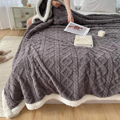Sherpa verzwaringsdeken op een bed