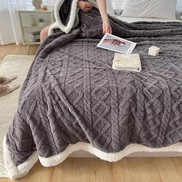 Sherpa verzwaringsdeken op een bed